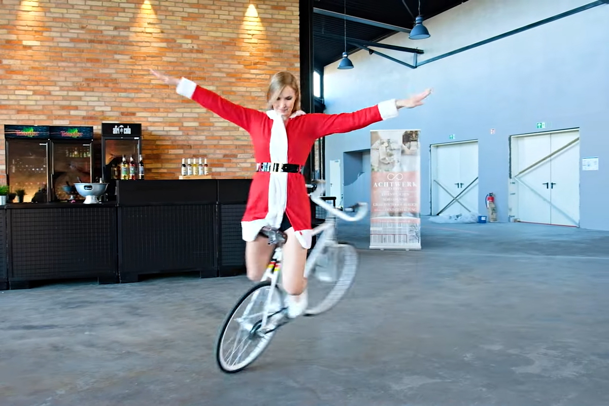 Miss Santa Does Some Amazing Bicycle Tricks